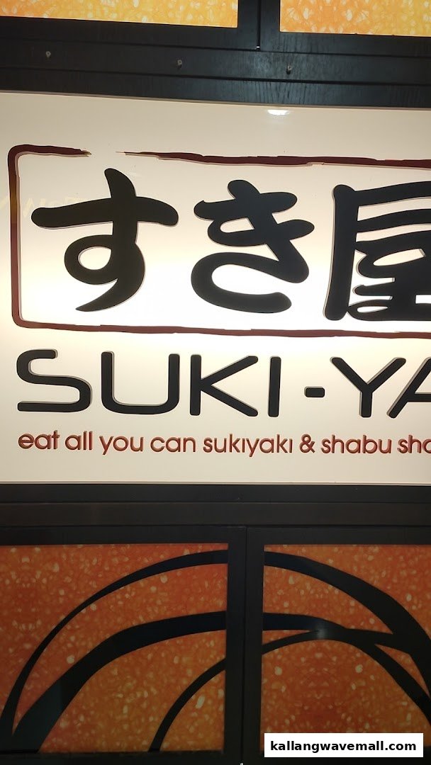 Close-up of the Suki-Ya shop sign, featuring Japanese and English branding with an 'all you can eat' tagline.