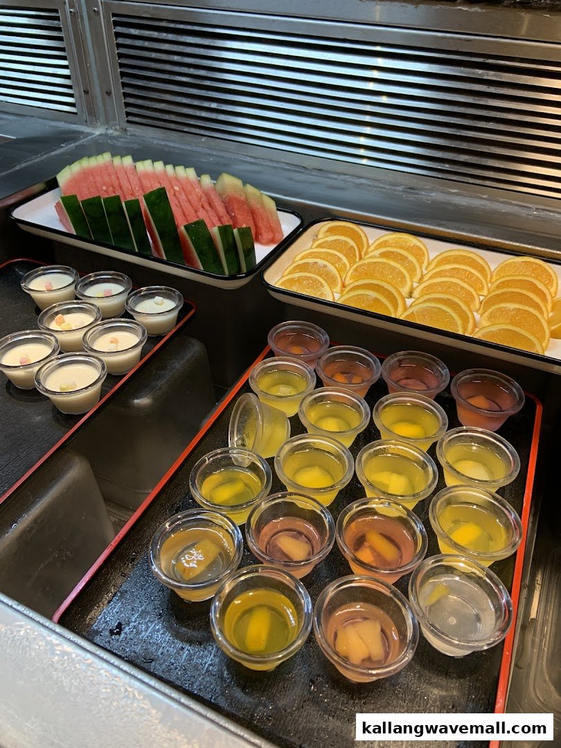 A buffet spread featuring fresh fruits, puddings, and jellies at Suki-Ya.