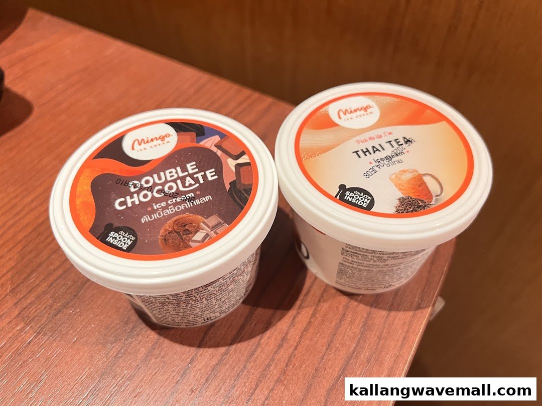 Two Mingo ice cream cups, 'Double Chocolate' and 'Thai Tea', displayed on a wooden surface.