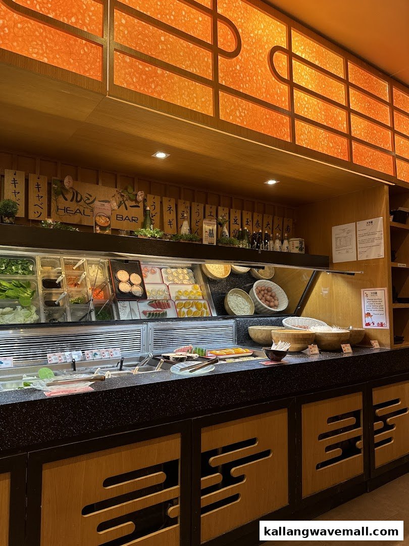 A vibrant shabu-shabu buffet bar at Suki-Ya, featuring a wide array of fresh vegetables and ingredients.