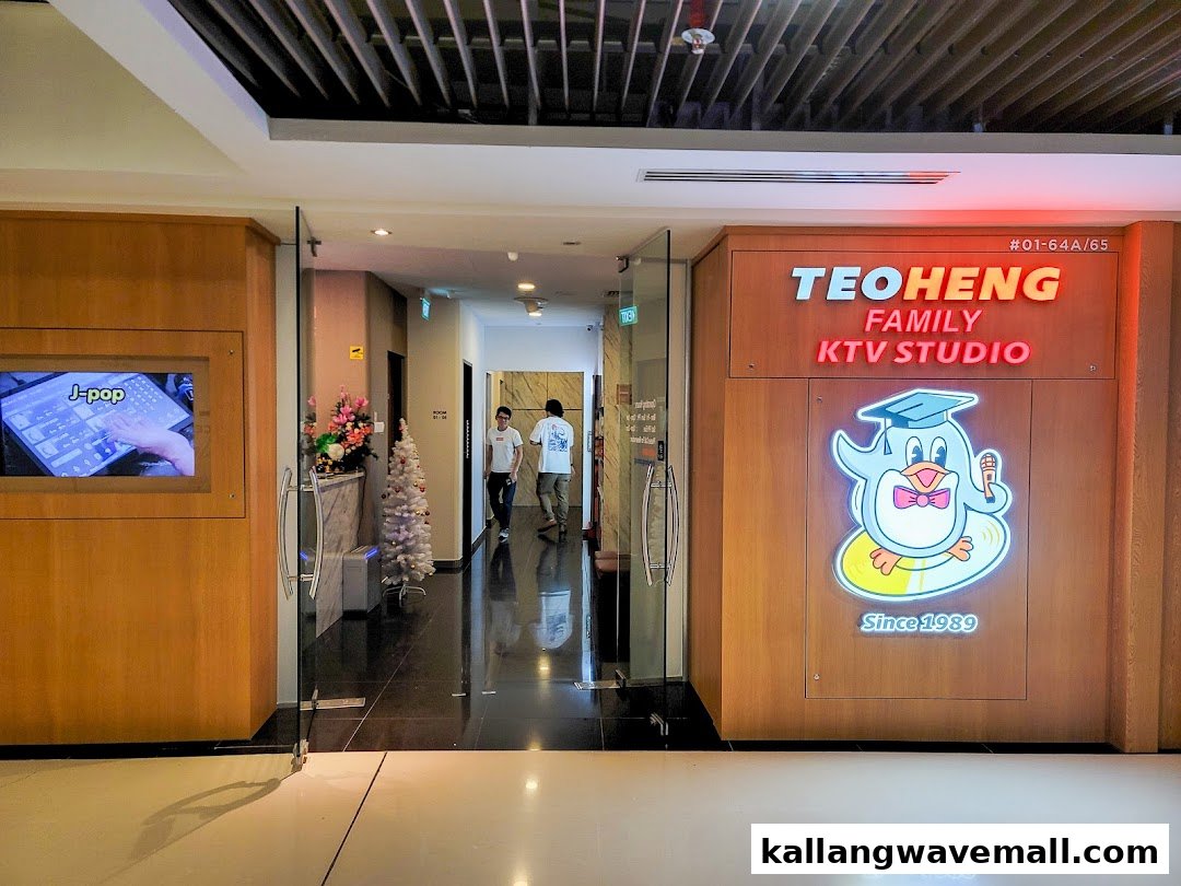 The inviting entrance of Teo Heng KTV Studio, featuring a vibrant sign and a J-pop display.