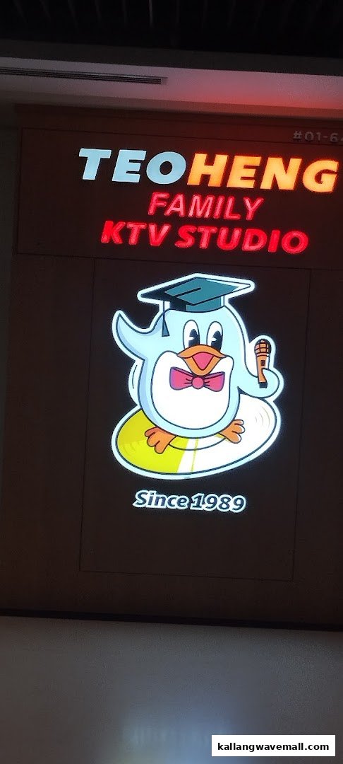 Illuminated sign for Teo Heng Family KTV Studio featuring a penguin mascot and 'Since 1989'.