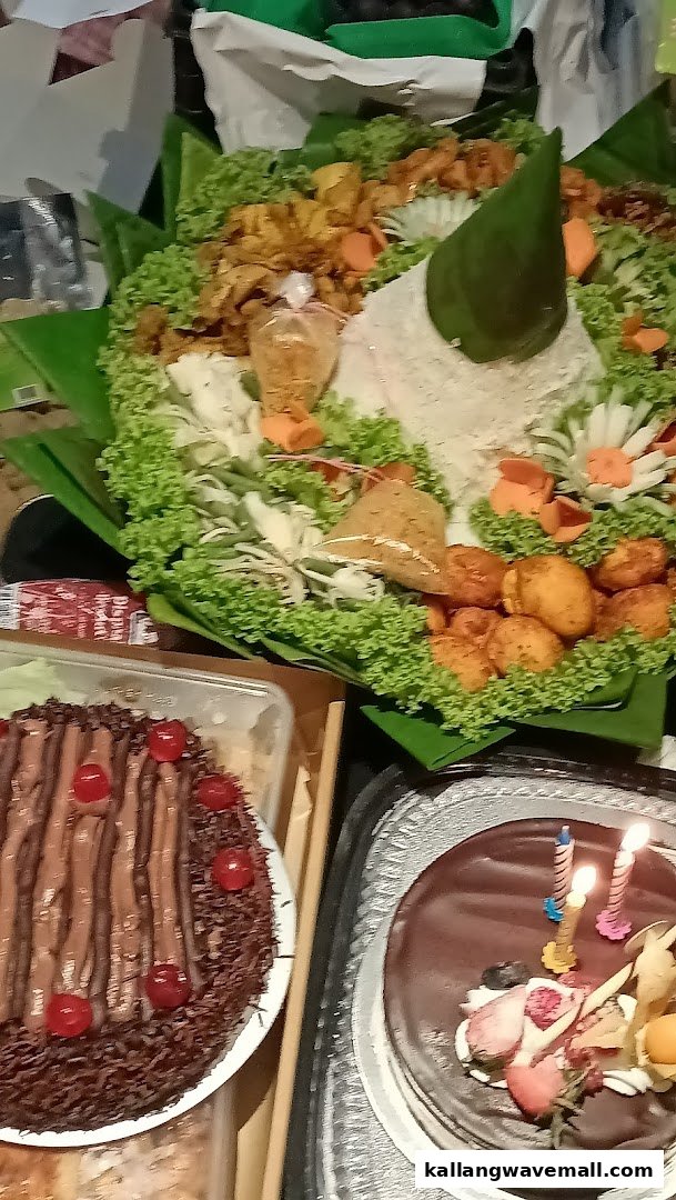 A vibrant spread of Nasi Tumpeng, cakes, and treats, perfect for a celebration.