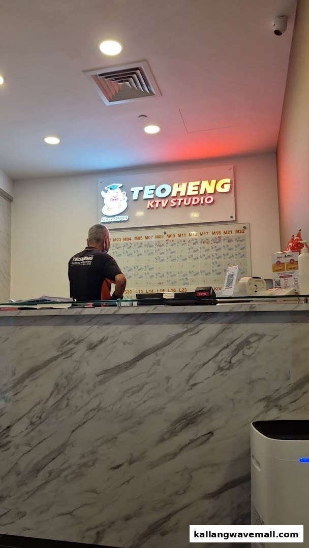 Reception area of Teo Heng KTV Studio with a staff member and booking board.