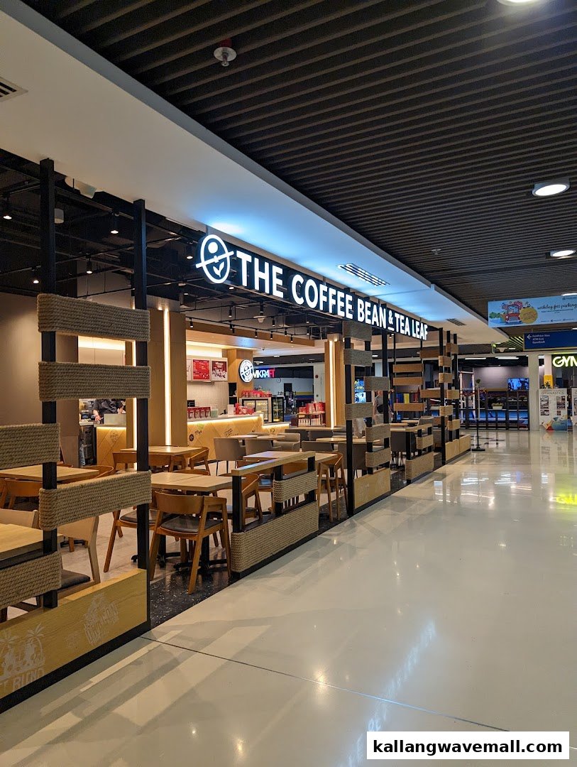 Exterior view of The Coffee Bean & Tea Leaf with prominent signage and inviting seating area.