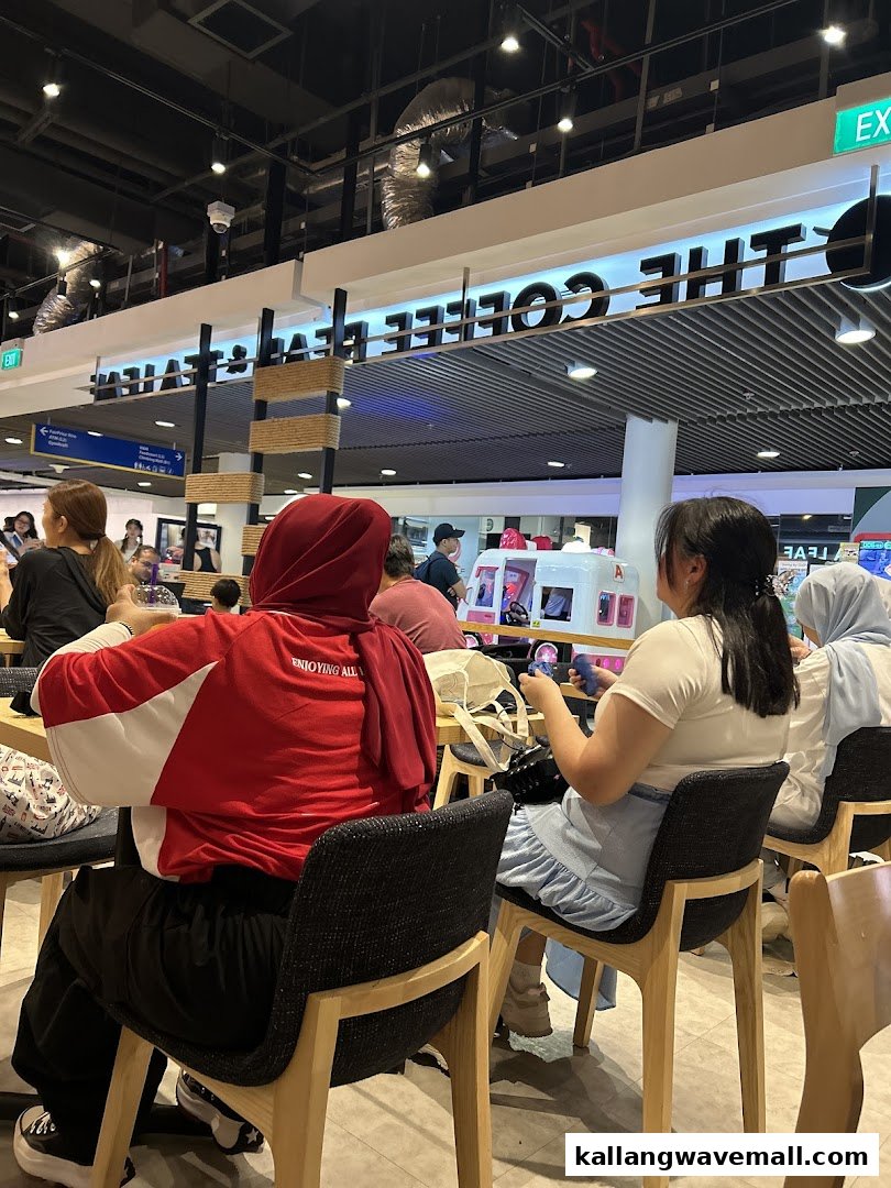Customers relax inside The Coffee Bean & Tea Leaf, enjoying the cafe's ambiance.