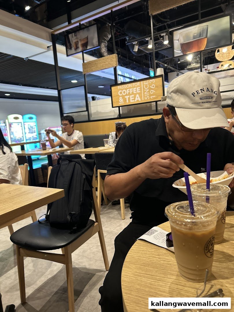Customers enjoying coffee and food inside The Coffee Bean & Tea Leaf.