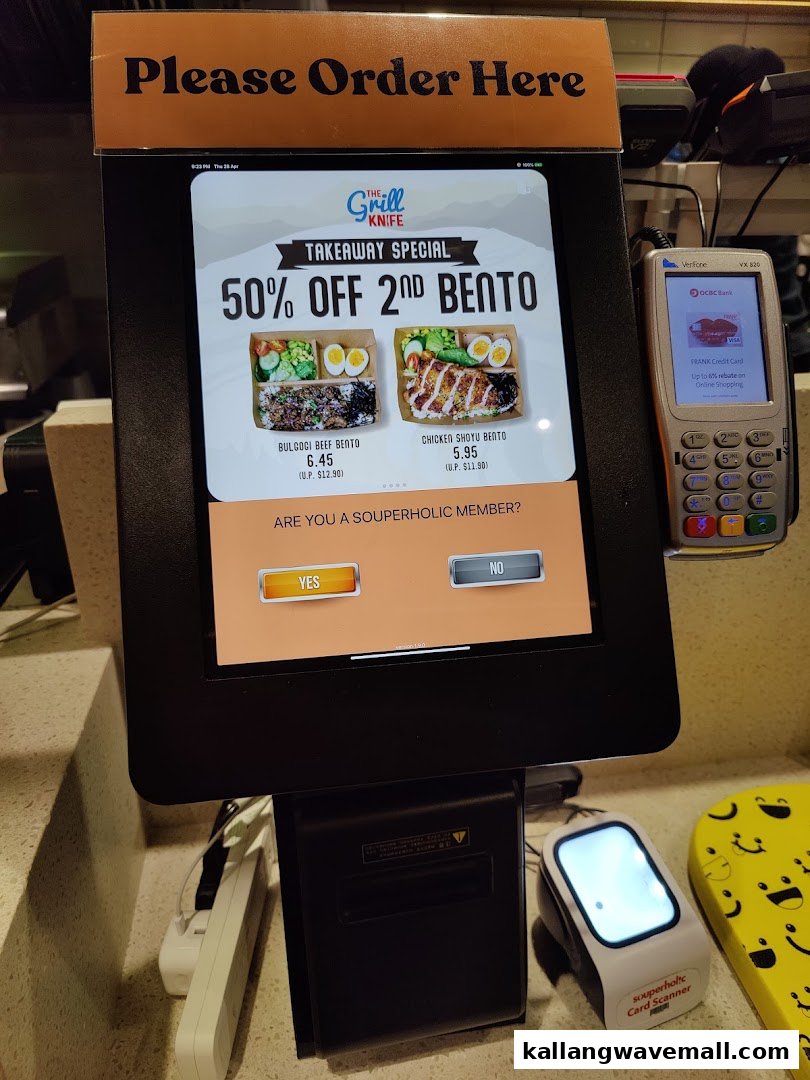 A self-order kiosk displaying a 'Takeaway Special' for bentos from The Grill Knife.