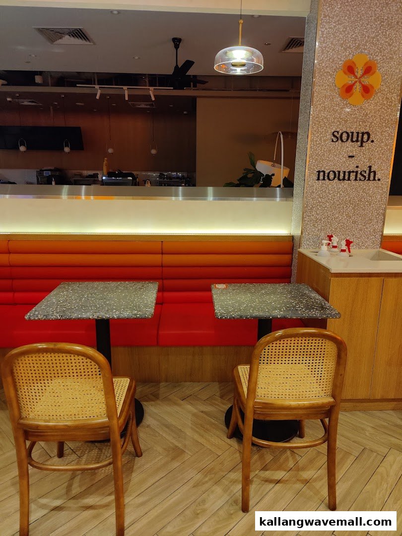 An inviting interior view of The Soup Spoon Union, featuring comfortable seating, tables, and a counter area.