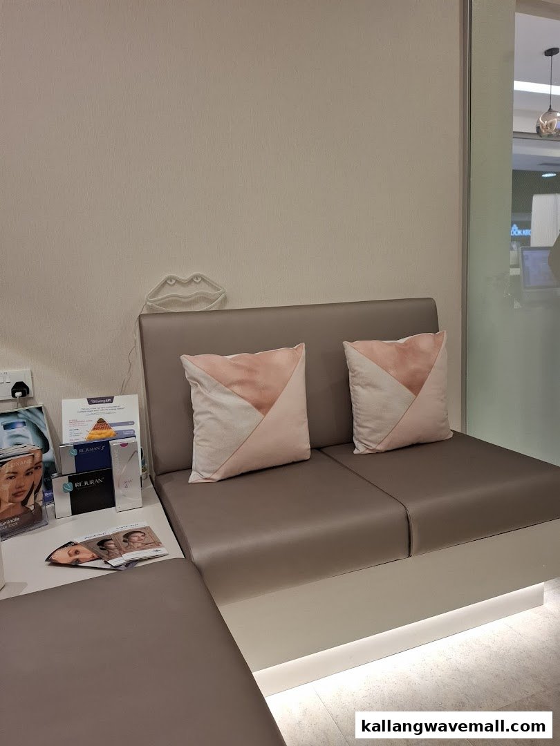 A modern, comfortable waiting area with seating and aesthetic product displays.