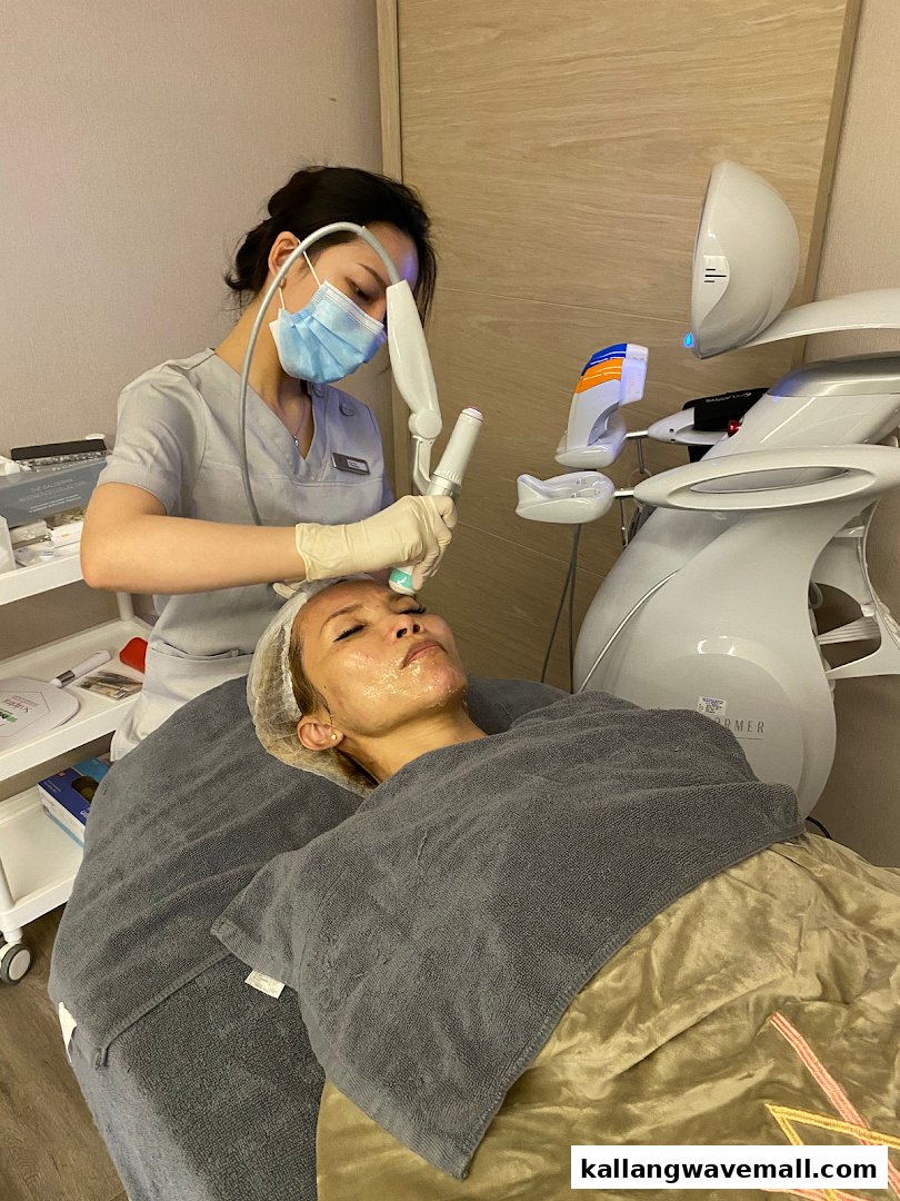 A technician performs a facial treatment on a client using advanced aesthetic equipment at Venusia Medical Aesthetics Clinic.