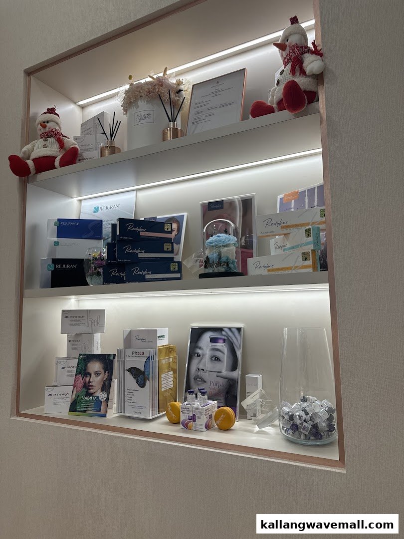 An illuminated display shelf showcasing medical aesthetic products like Rejuran, Restylane, and Nabota, with decorative elements.
