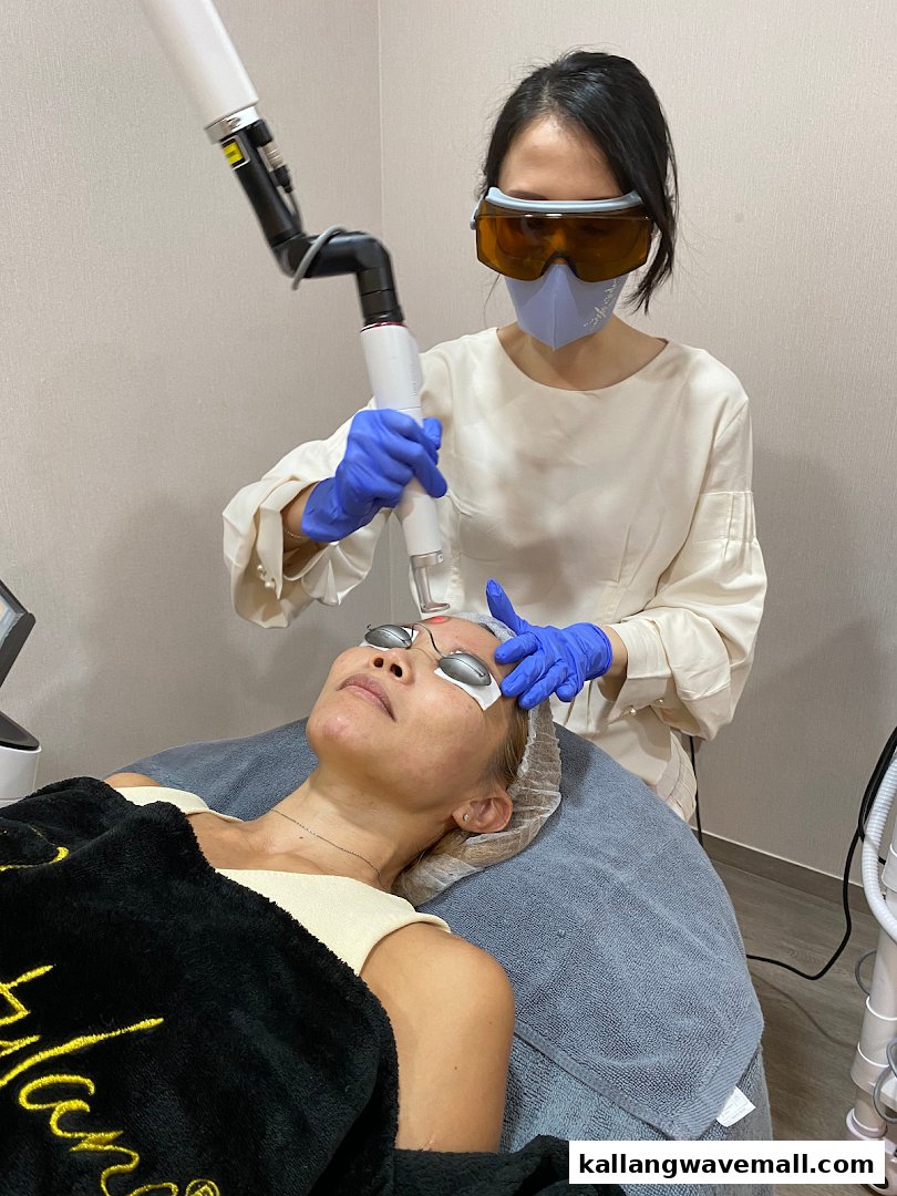 A professional performs a laser aesthetic treatment on a client's face at Venusia Medical Aesthetics Clinic.