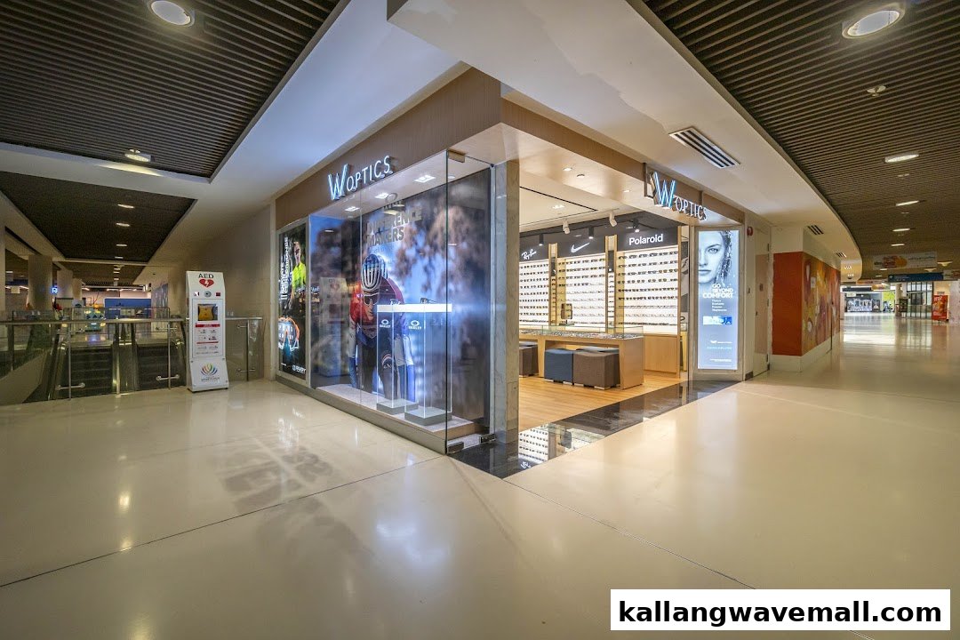 The W Optics shop front features large glass windows displaying eyewear and promotional visuals within a modern mall setting.