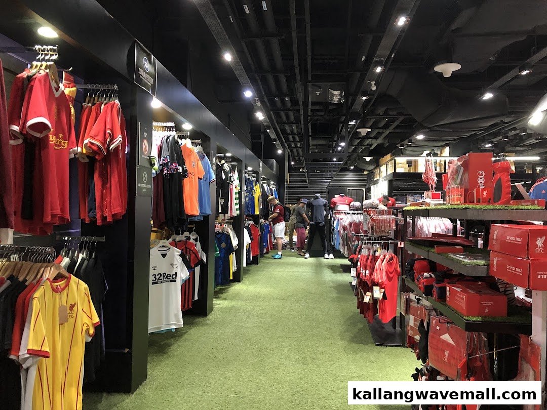 Interior view of a sports merchandise store, featuring rows of football jerseys and fan gear on display.