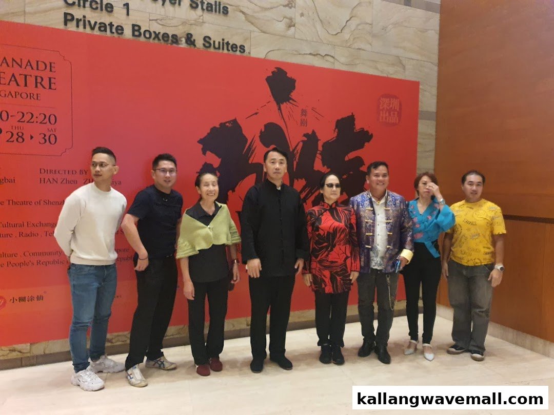 A group of people posing in front of a large red event banner at a venue.