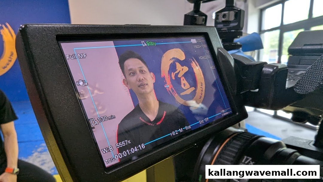 A camera monitor displays a man being filmed, likely for promotional content, inside Xuan Sports.