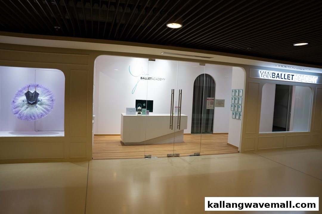 The shop front of Yan Ballet Academy featuring a display tutu and glass entrance.