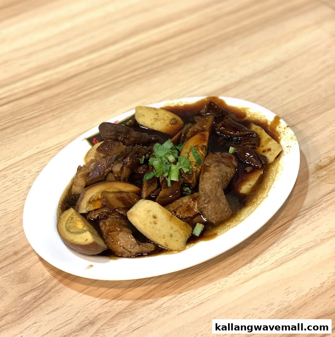 A plate of delicious braised pork, tofu, and egg in a rich dark sauce.