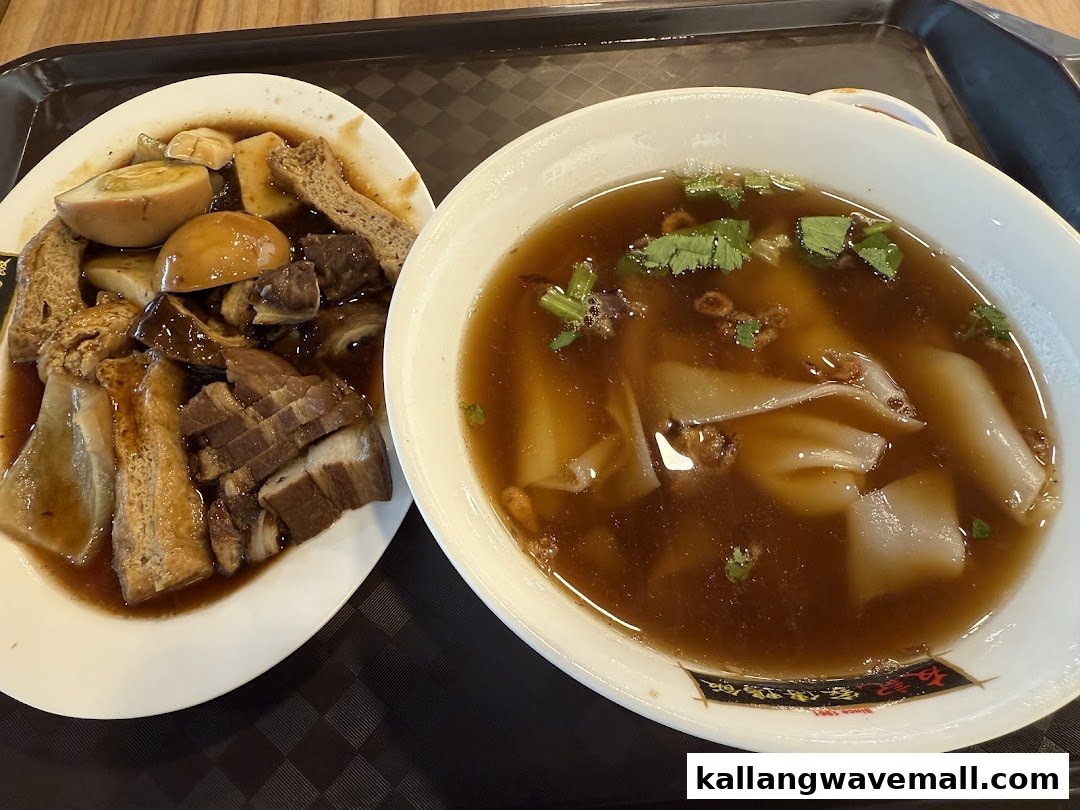 A delicious meal featuring braised pork, eggs, and tofu alongside a bowl of kway chap soup.