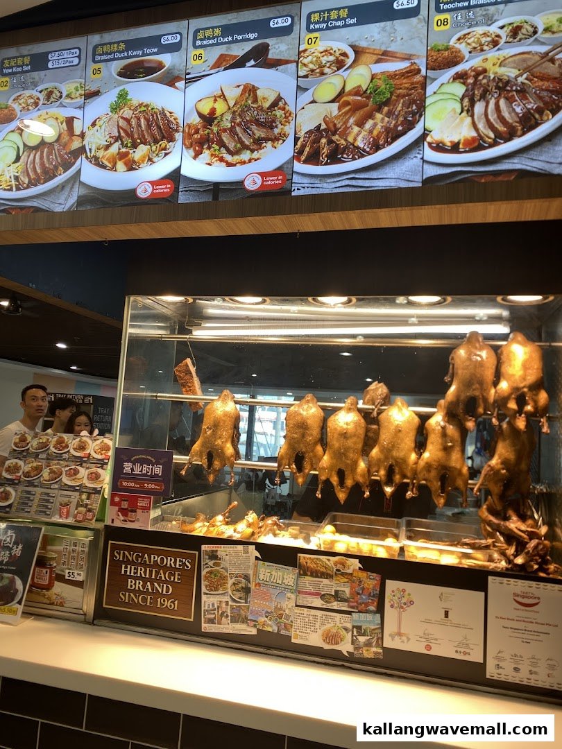 A display of delicious braised duck dishes and other Singaporean specialties with visible menu boards and prices.
