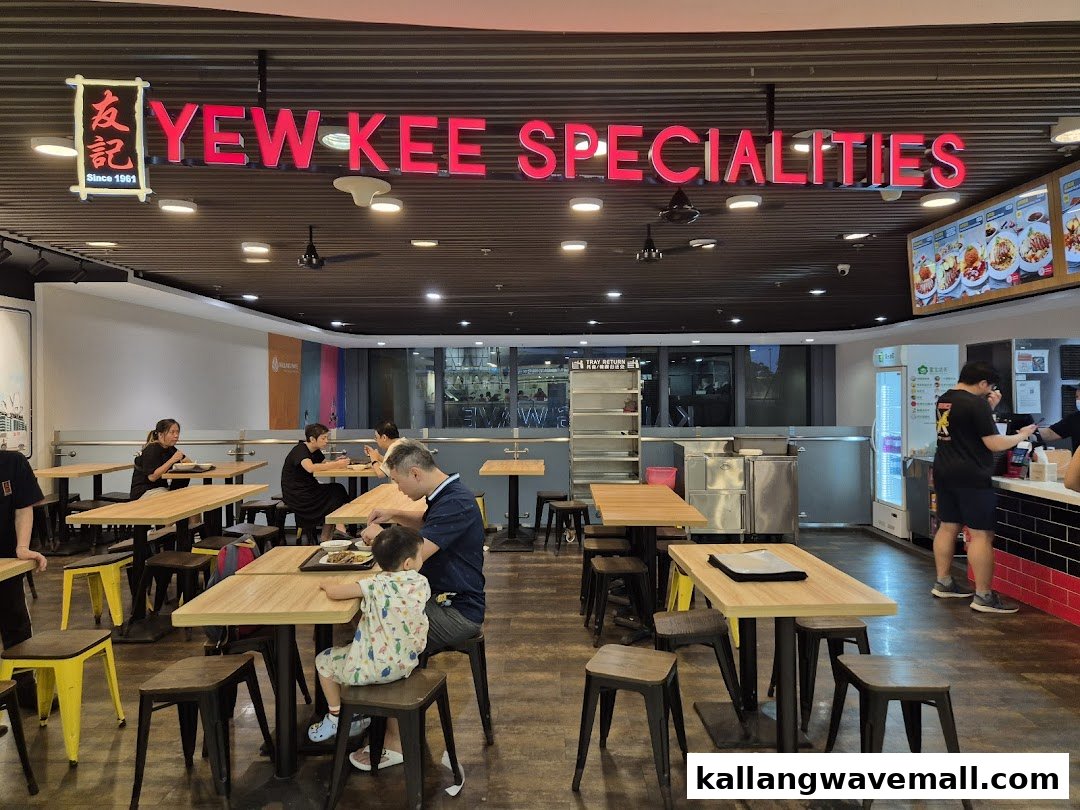 Interior view of Yew Kee Specialities with customers dining at tables and staff at the counter.