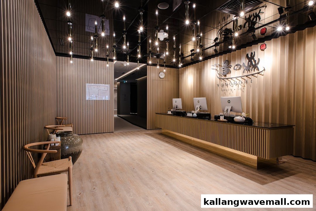The modern and inviting reception area of Yunomori Onsen Spa, featuring a sleek counter and warm lighting.