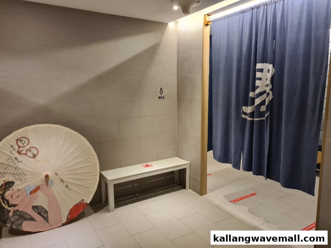 An interior view of Yunomori Onsen Spa, featuring a Japanese noren curtain and a decorative umbrella.