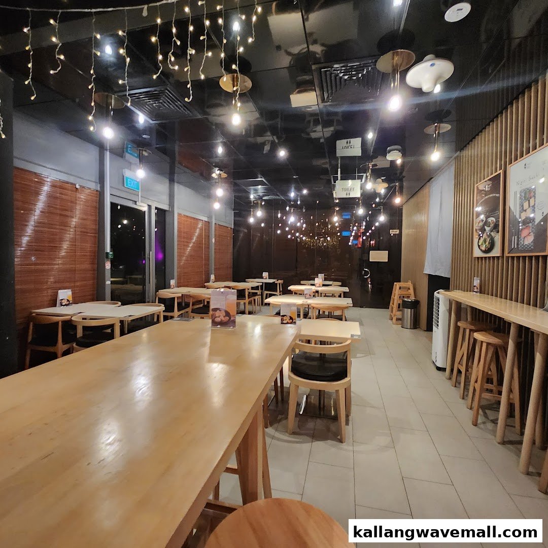 A cozy interior dining area with wooden furniture and warm string lights.