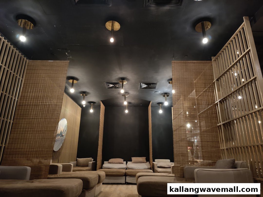 A serene, dimly lit relaxation area with comfortable lounge seating and Japanese-inspired decor at Yunomori Onsen & Spa.