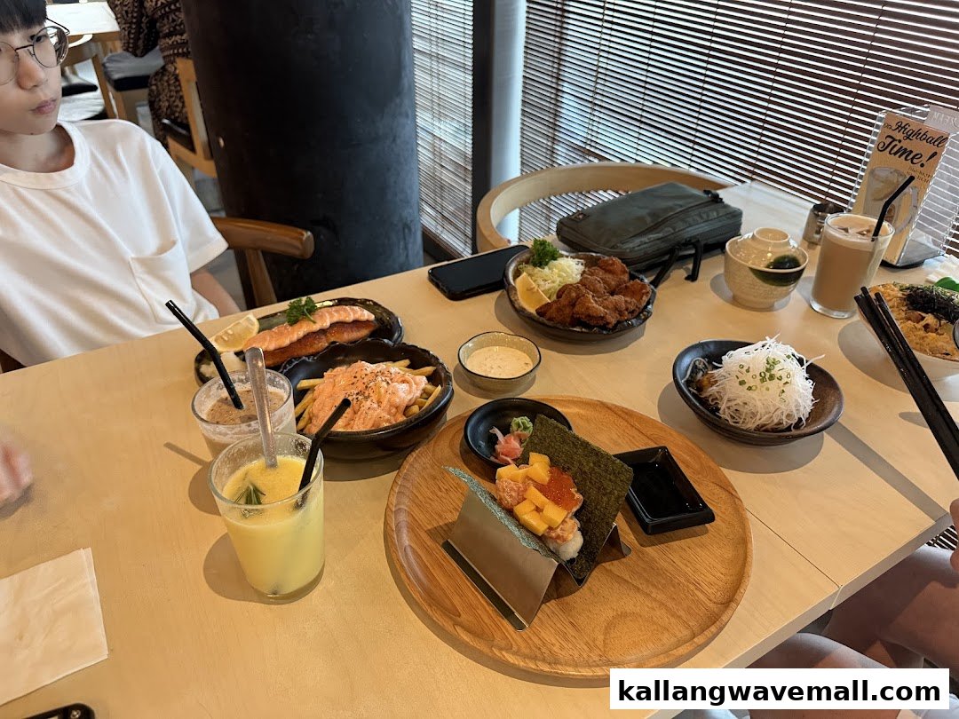 A table laden with various Japanese-inspired dishes and drinks, enjoyed by diners in a relaxed setting.