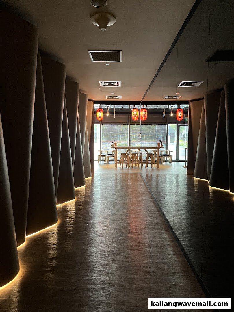 A serene hallway with Japanese lanterns leads to a bright seating area at Yunomori Onsen & Spa.