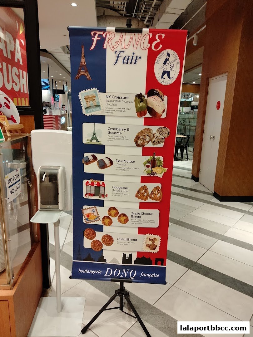 A banner advertising a France Fair with various French pastries and breads from DONQ.