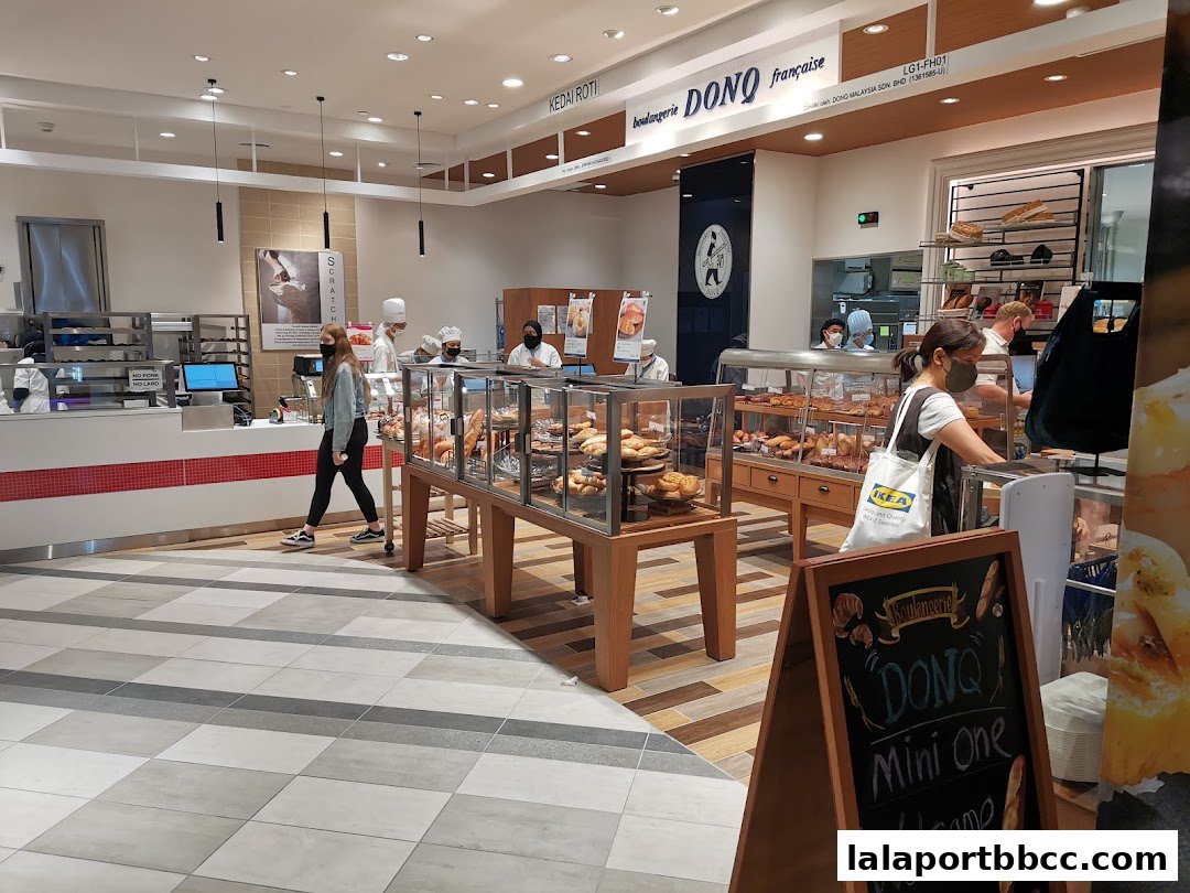 Interior view of a bakery with display cases full of bread and pastries.