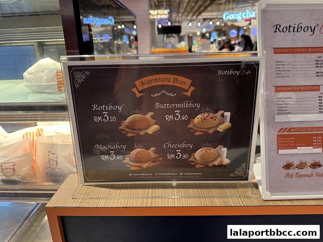 A menu board displaying Roti Boy signature buns and various coffee and tea selections.