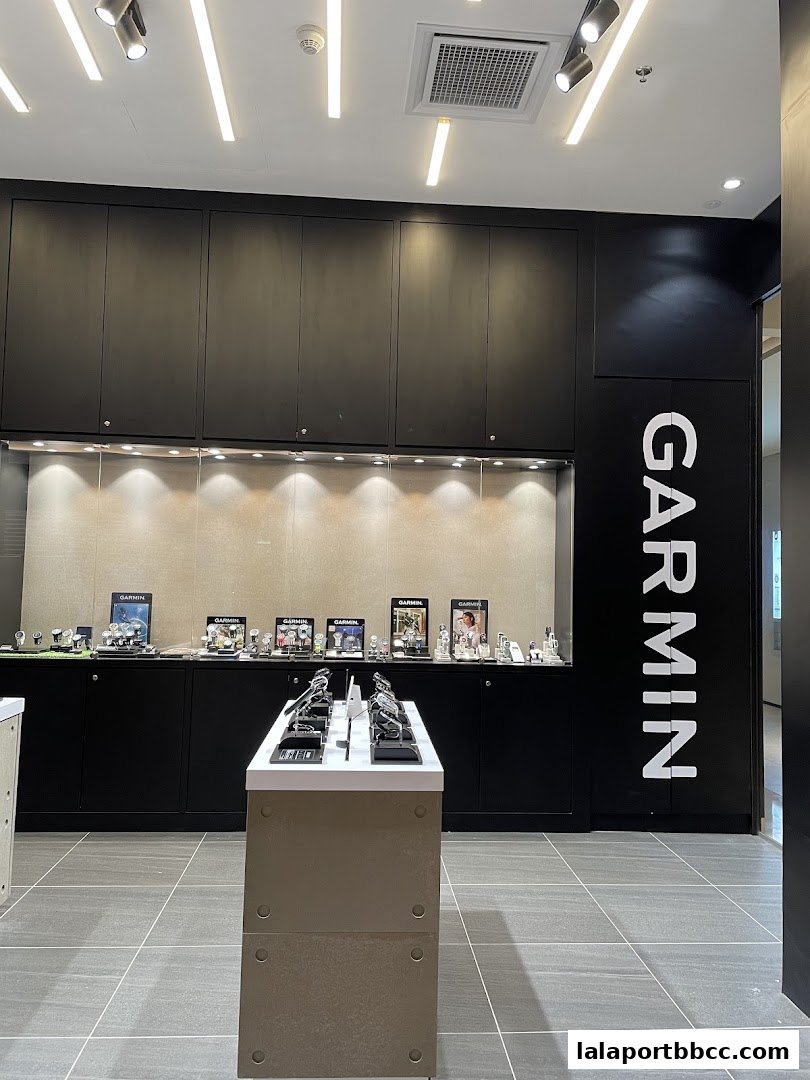 Interior view of a Garmin store showcasing watches on display shelves and a central display unit.