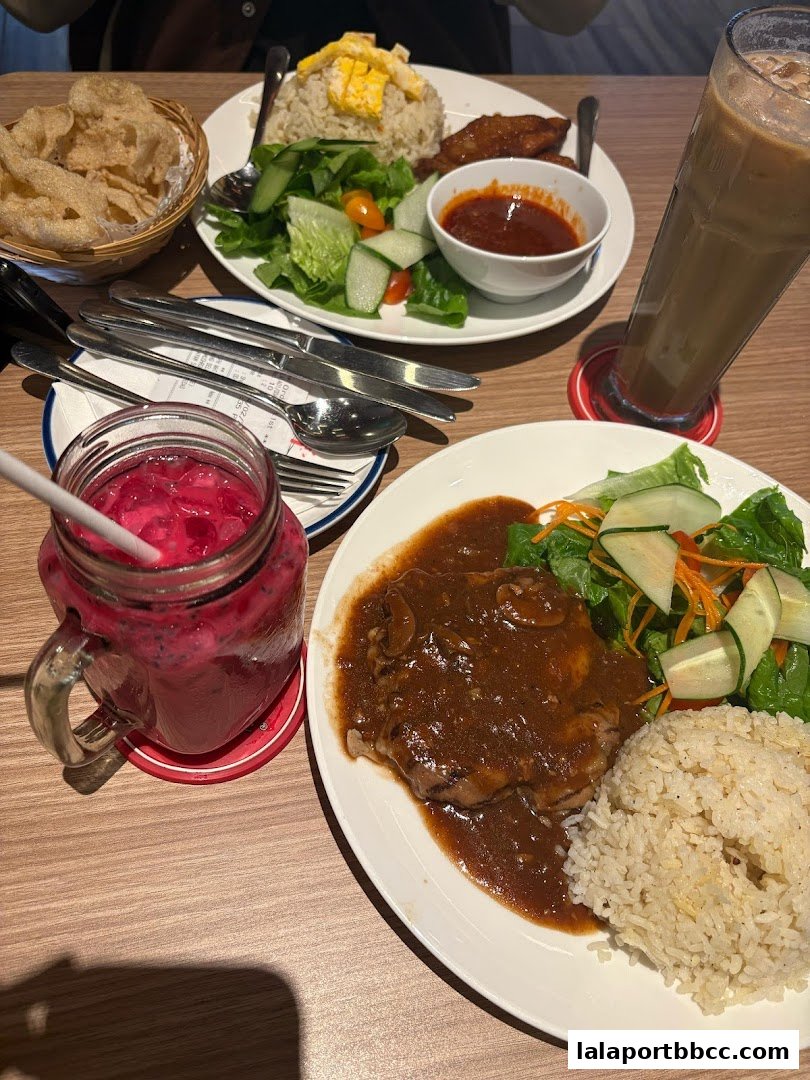 Two delicious meals and drinks served on a wooden table at Secret Recipe.