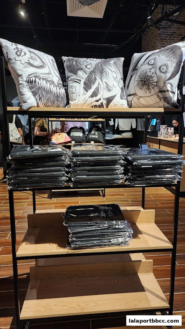 Shelves display Junji Ito themed merchandise, including pillows and packaged items.