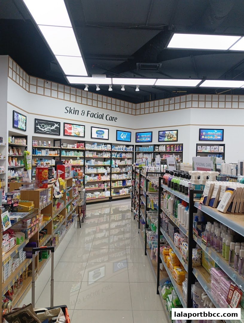 Interior view of a well-stocked pharmacy with shelves of health and beauty products.