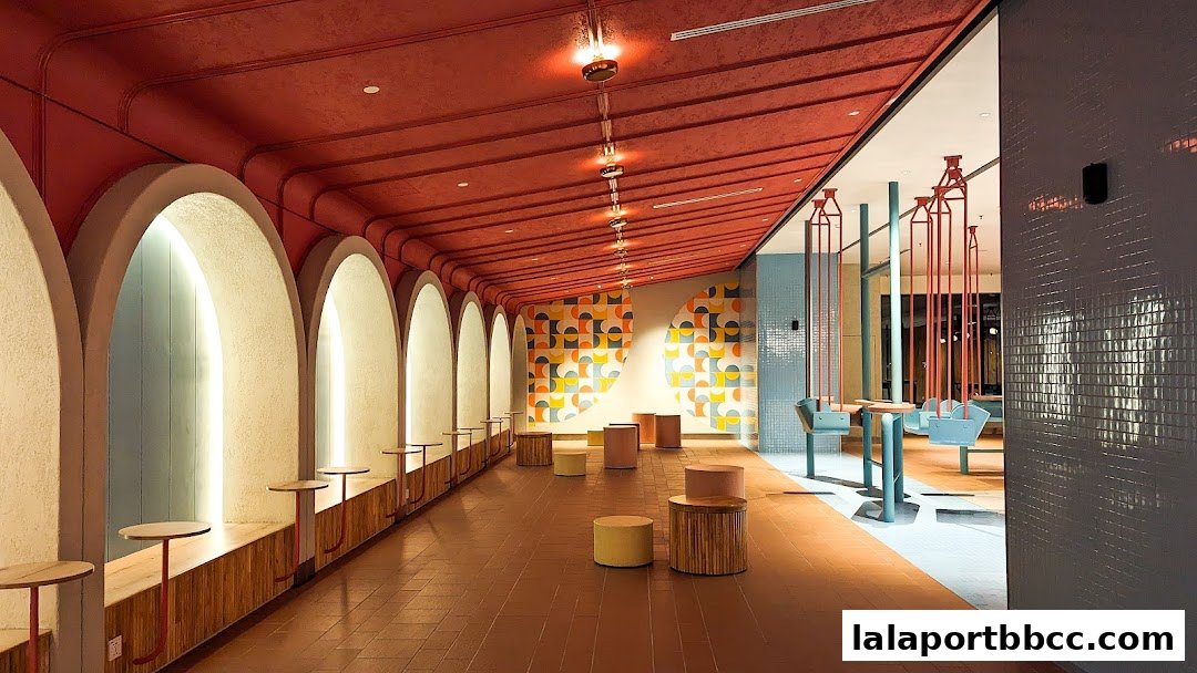 Interior view of a stylish cafe with arched walkways, colorful decor, and unique seating.
