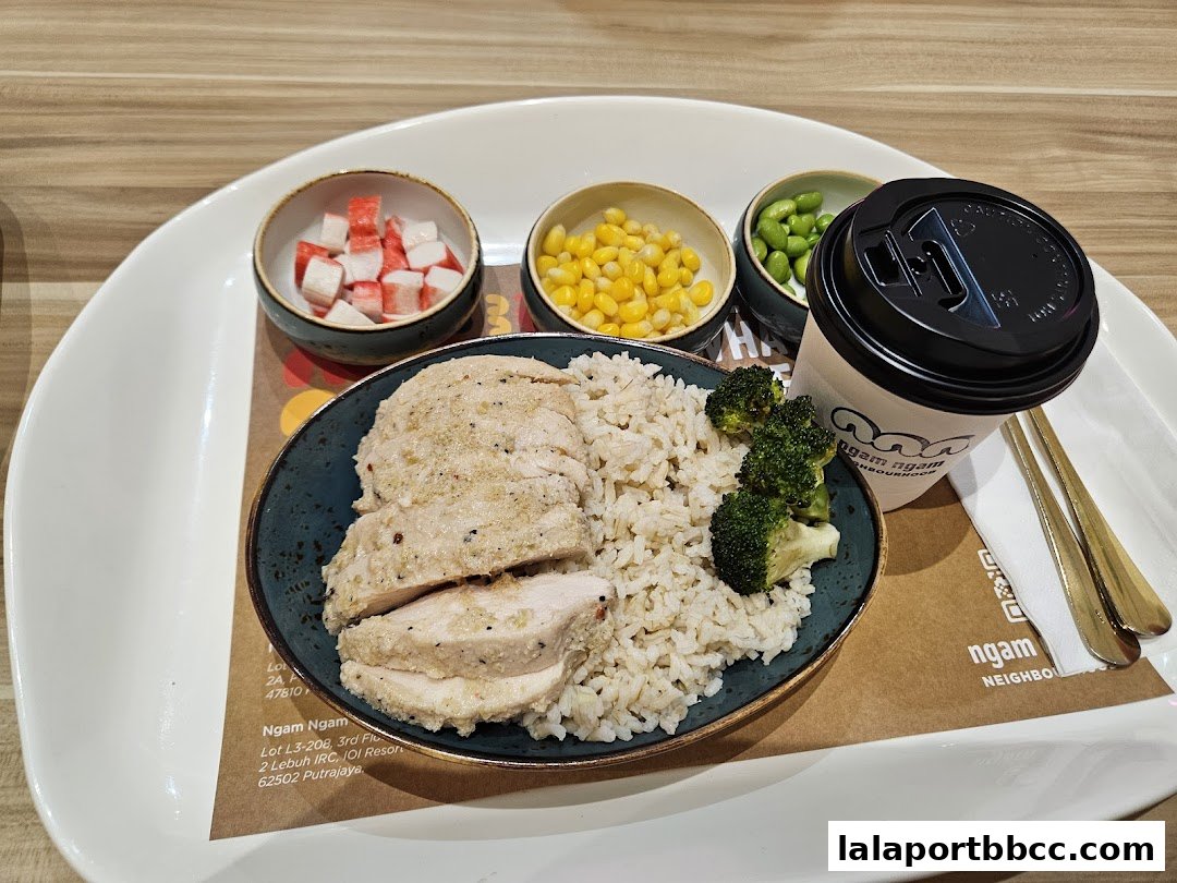 A healthy meal with sliced chicken breast, rice, broccoli, corn, edamame, and imitation crab meat.