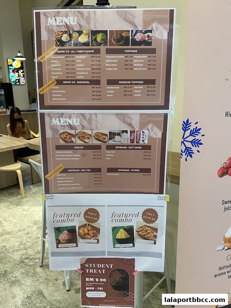 A menu board displaying various snow ice flavors, toppings, snacks, beverages, and combo deals.