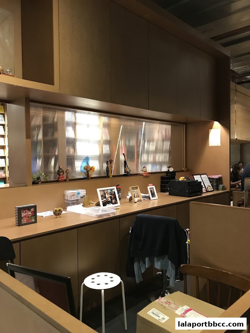 Interior view of a shop counter with decorative items and a chair.