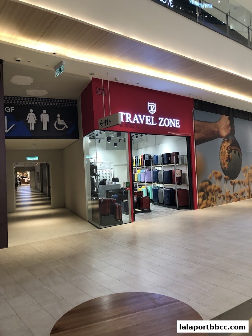 The Travel Zone shop front displays a variety of colorful luggage and travel bags.