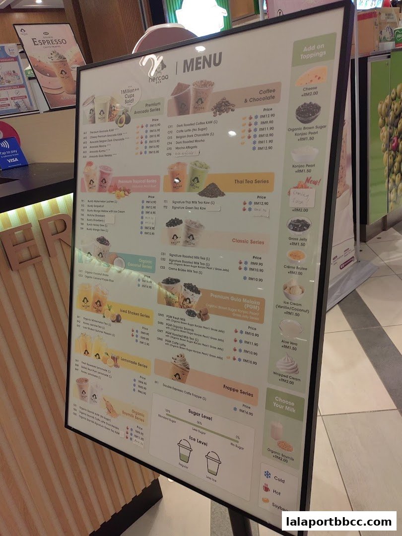 A menu board displaying various drinks and toppings from Hercaa Lalaport.