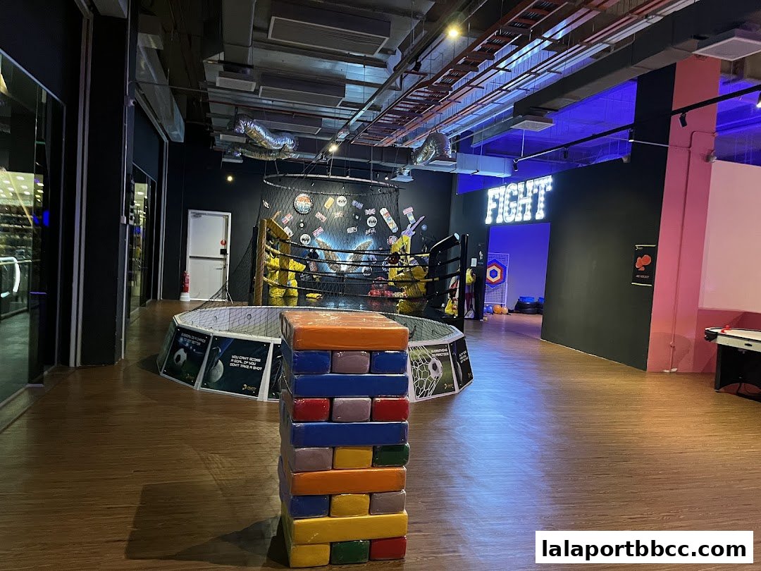Interior view of PartyBox 360 with a boxing ring and games.