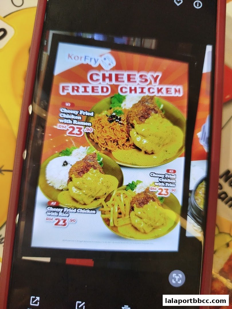 A menu display for KorFry's Cheesy Fried Chicken with various meal options.