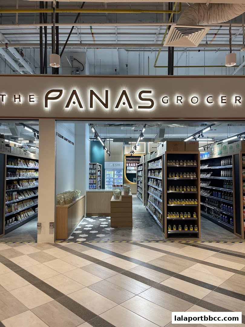 The entrance of The Panas Grocer, showcasing shelves stocked with various products.