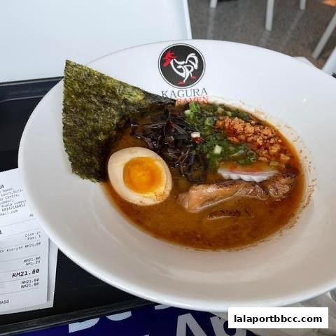 A delicious bowl of Kagura Tokyo Chicken Ramen with a perfectly cooked egg and rich broth.