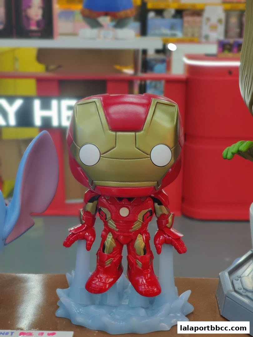 A close-up of an Iron Man Funko Pop figure displayed in a toy store.
